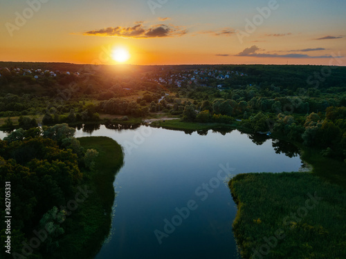 Sunset above the river in natural rural landscape