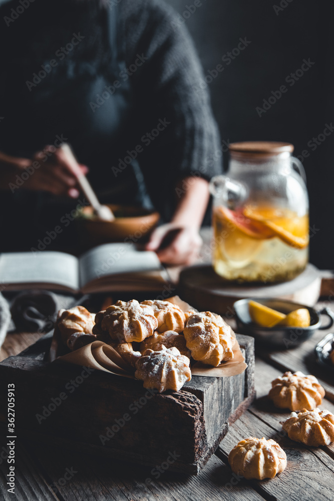 Woman cooks in a vintage kitchen on wooden tablet. Healthy drink, Eco, vegan.