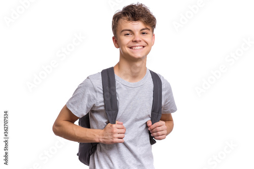 Student teen boy with backpack looking at camera. Portrait of cute smiling schoolboy, isolated on white background. Happy child Back to school. photo