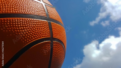 Basketball ball on sky background.