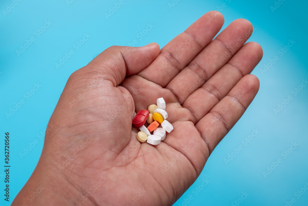 Many pills on the patient's hand Many pills on the patient's hand