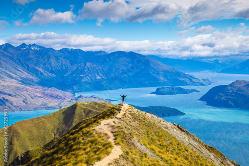 Roys peak mountain hike in Wanaka New Zealand. Popular tourism travel destination. Concept for hiking travel and adventure. New Zealand landscape background.	 photo