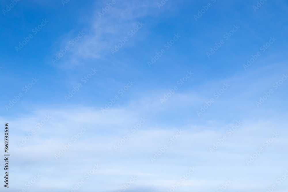 Clear blue sky with white cloud background