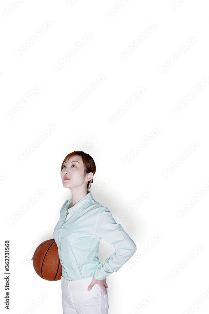Businesswoman holding a basketball Businesswoman holding a basketball
