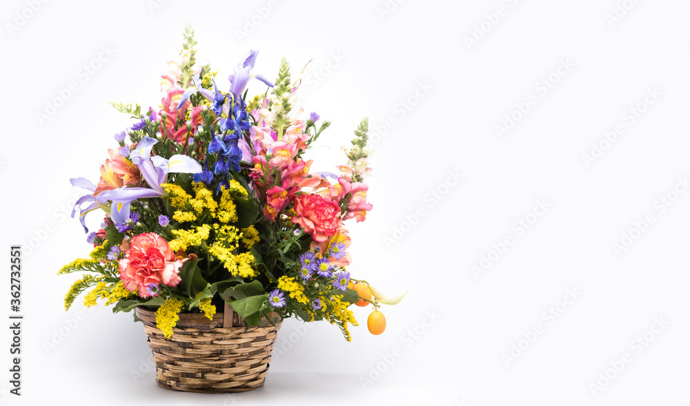 bouquet of bright flowers in basket isolated on white background. Mothers Day or Valentines Day Concept.  Copy Space