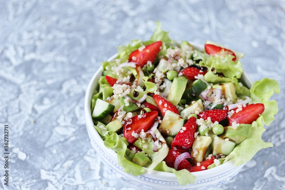 Salad with strawberries, quinoa, avocado, cucumber, lettuce, onions and green peas. vegetarian food.copy space Salad with strawberries, quinoa, avocado, cucumber, lettuce, onions and green peas. vegetarian food.copy space