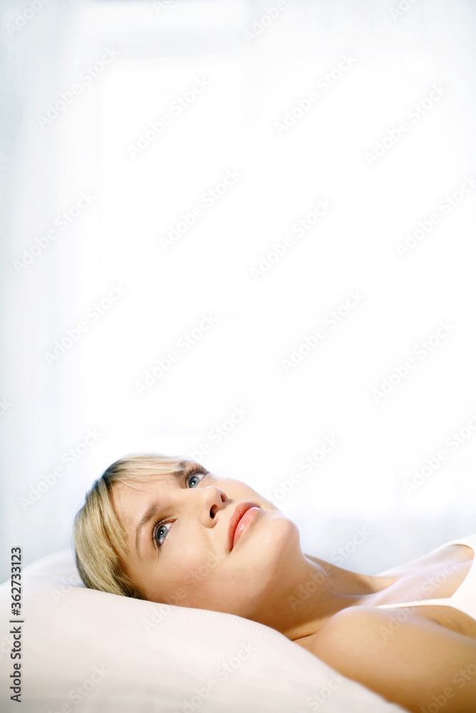 Fototapeta premium Woman lying on the bed