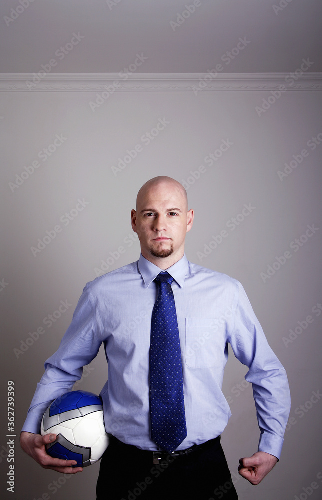 Businessman holding a soccer ball Businessman holding a soccer ball