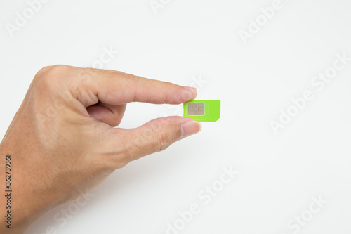 Hand holding SIM card on white background