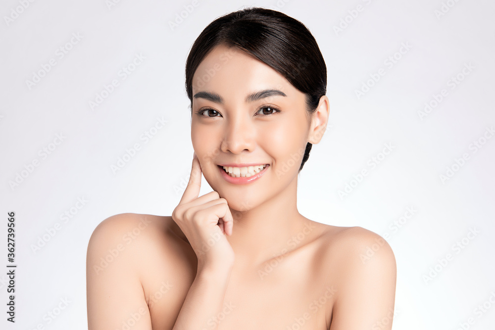 Beauty face. Smiling asian woman touching healthy skin portrait. Beautiful happy girl model with fresh glowing hydrated facial skin and natural makeup on white background Beauty face. Smiling asian woman touching healthy skin portrait. Beautiful happy girl model with fresh glowing hydrated facial skin and natural makeup on white background