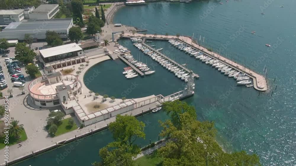 Beautiful drone view of the marina and the blue water of the gardalake in Riva Del Garda, a small town in the region of Trentino Alto Adige in North Italy Beautiful drone view of the marina and the blue water of the gardalake in Riva Del Garda, a small town in the region of Trentino Alto Adige in North Italy