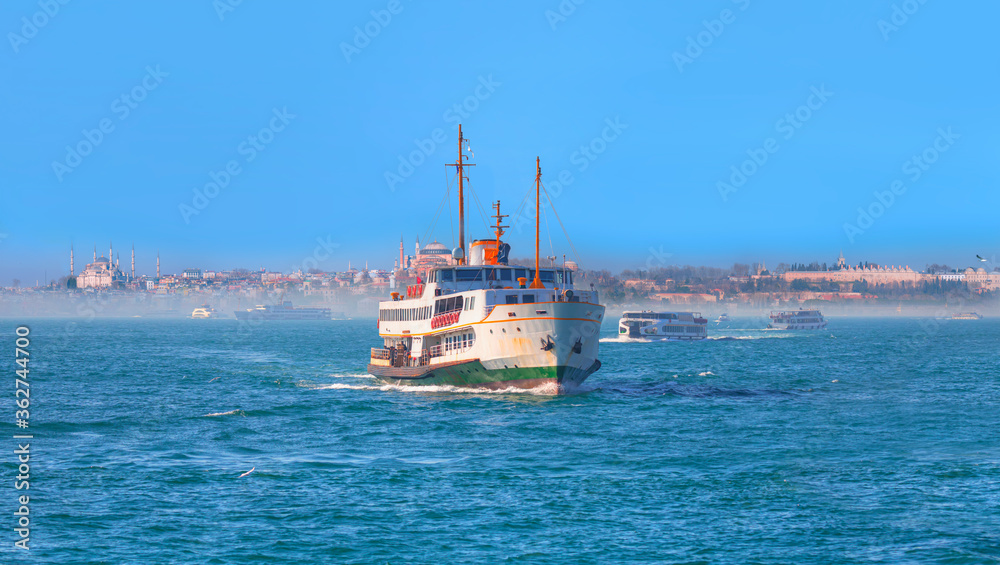 Famous historical peninsula of Istanbul - Hagia sophia, Sultanahmet Mosque,  - Istanbul, Turkey - Water trail foaming behind a passenger ferry boat in Bosphorus, Istanbul, Turkey