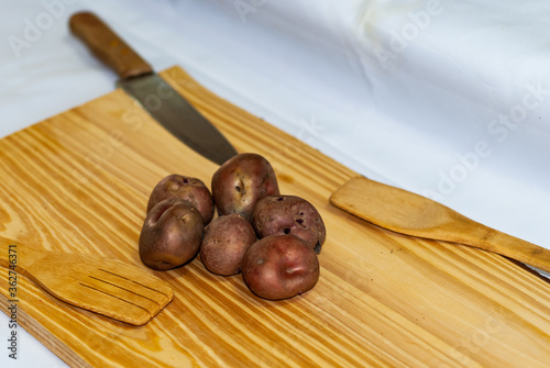 regional potatoes from the Andes at a market in Peru, Bolivia, Argentina, south america on a wooden table. Selective focus photo