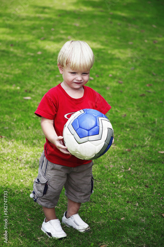 Little boy holding a ball