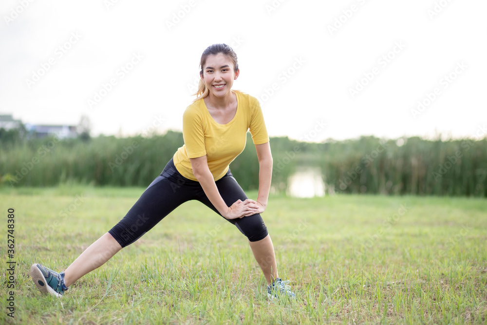 Asian women stretching before exercising in the park. Asian women stretching before exercising in the park.