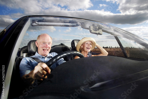 Senior couple traveling in the car