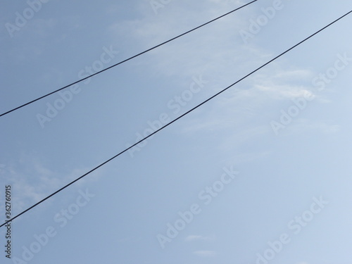 Electrical cables on blue sky background