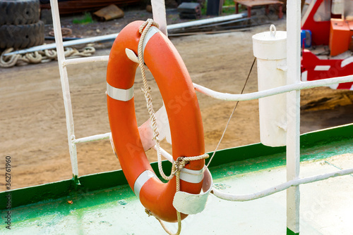 Orange life buoy hanging in a handrail