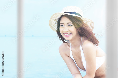 Asian woman with bikini and hat relaxing