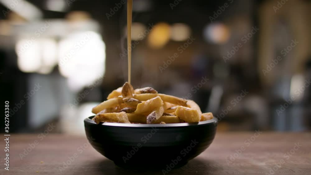 Gravy pour on some fresh cut fries. Amazing pub food ready to be eaten. Delicious and flavourful food. Shot in 4k. 