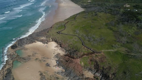 Reveal aerial drone shot of the champagne pools and Indian Head on Fraser Island (Australia) photo