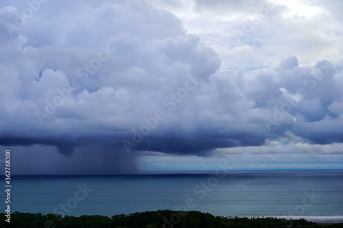 Beautiful aerial view of a Strong rain storm in the middle of the ocean, near the beach of Costa Rica