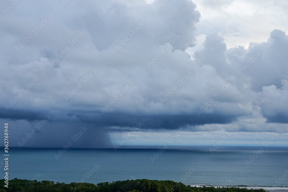 Beautiful aerial view of a Strong rain storm in the middle of the ocean, near the beach of Costa Rica