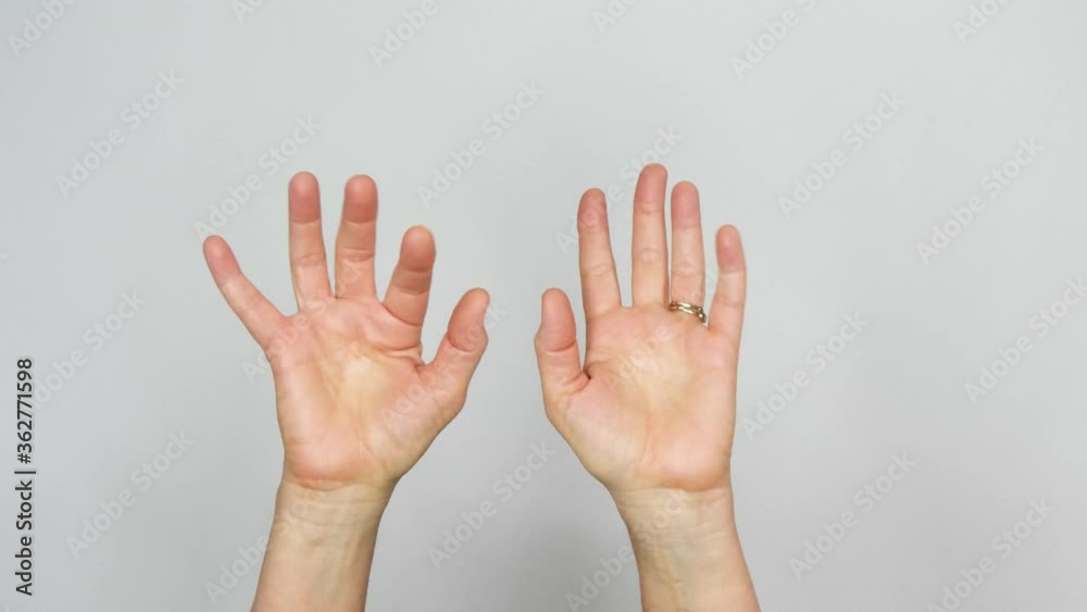 Two hands are seen doing magic fingers with the fingers flickering energetically in front of a white background. Two hands are seen doing magic fingers with the fingers flickering energetically in front of a white background.
