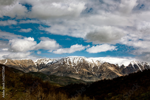 snowy mountain and green filed in turkey