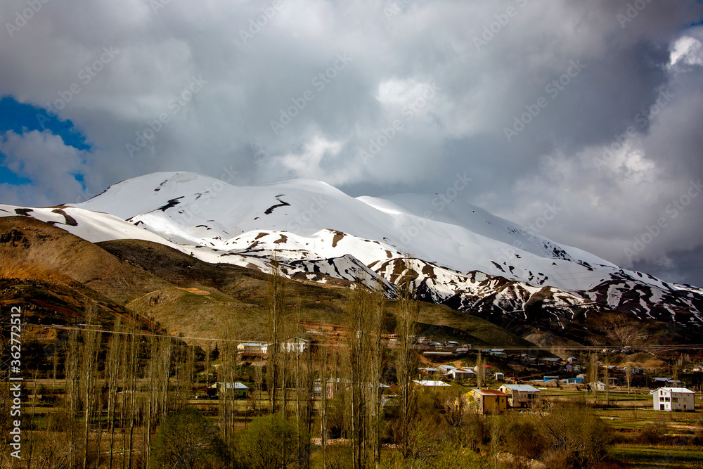 snowy mountain and green filed in turkey