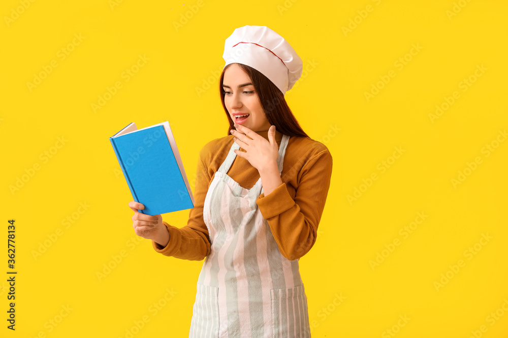 Young woman with recipe book on color background Young woman with recipe book on color background
