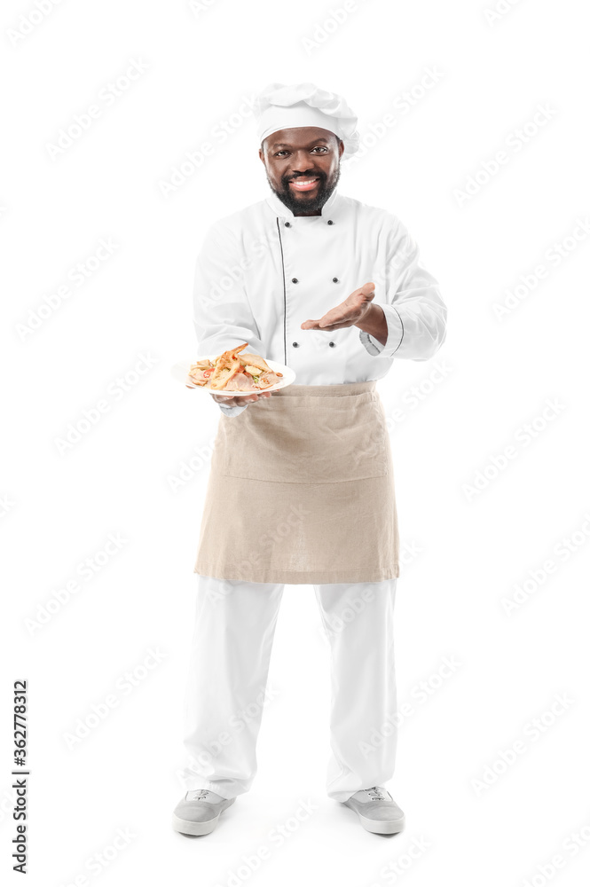 Male African-American chef with tasty dish on white background Male African-American chef with tasty dish on white background