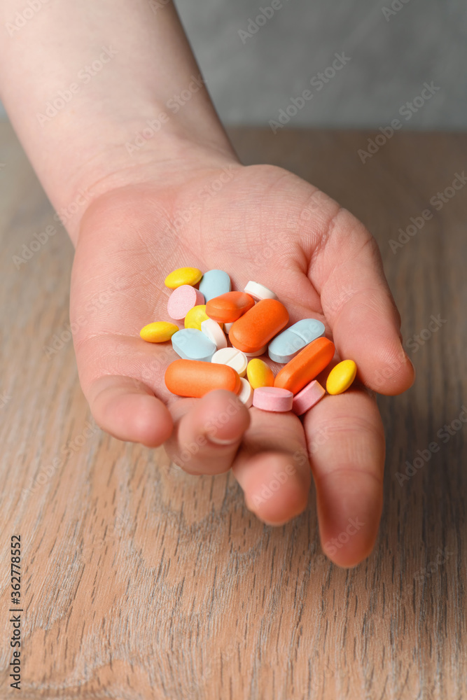 Several colored tablets in hand close-up. Concept of assistance in case of illness. Help with viral infection. Several colored tablets in hand close-up. Concept of assistance in case of illness. Help with viral infection.