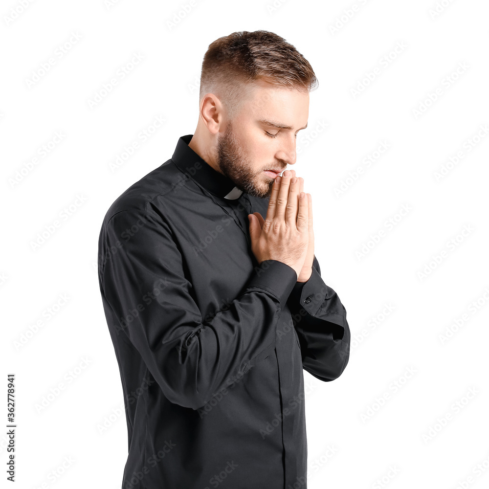Young priest praying to God on white background Young priest praying to God on white background
