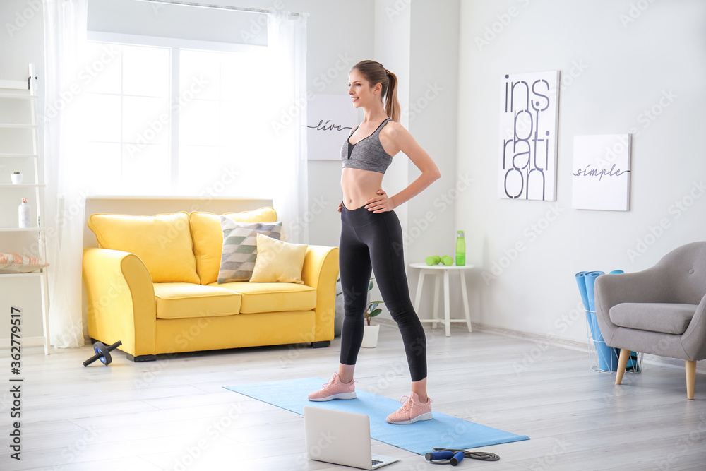Sporty young woman training at home Sporty young woman training at home