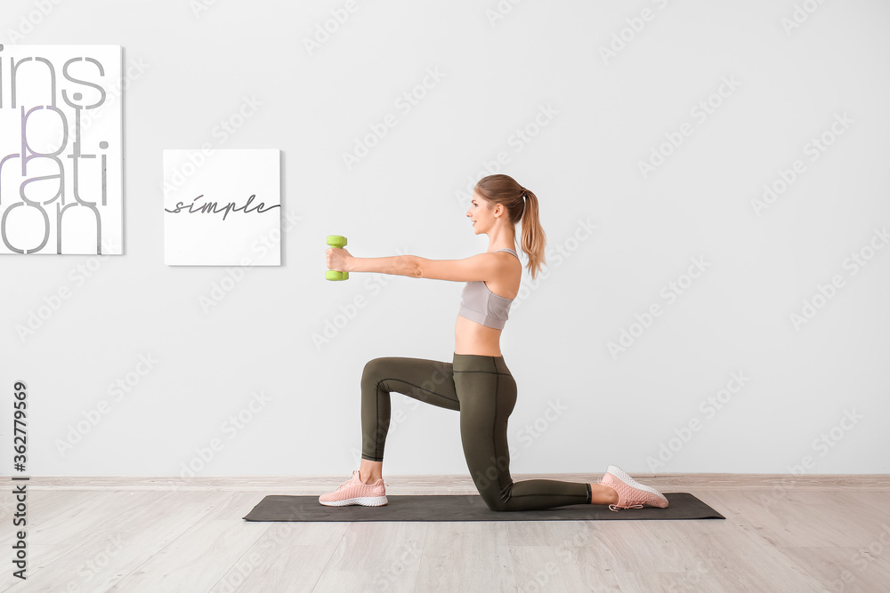 Sporty young woman training at home Sporty young woman training at home