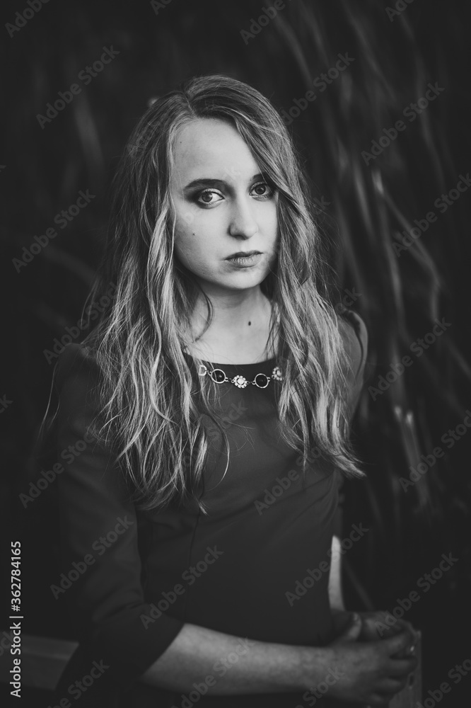 Portrait of a beautiful girl in autumn against the background of the field on the nature..Black and white photo. Portrait of a beautiful girl in autumn against the background of the field on the nature..Black and white photo.