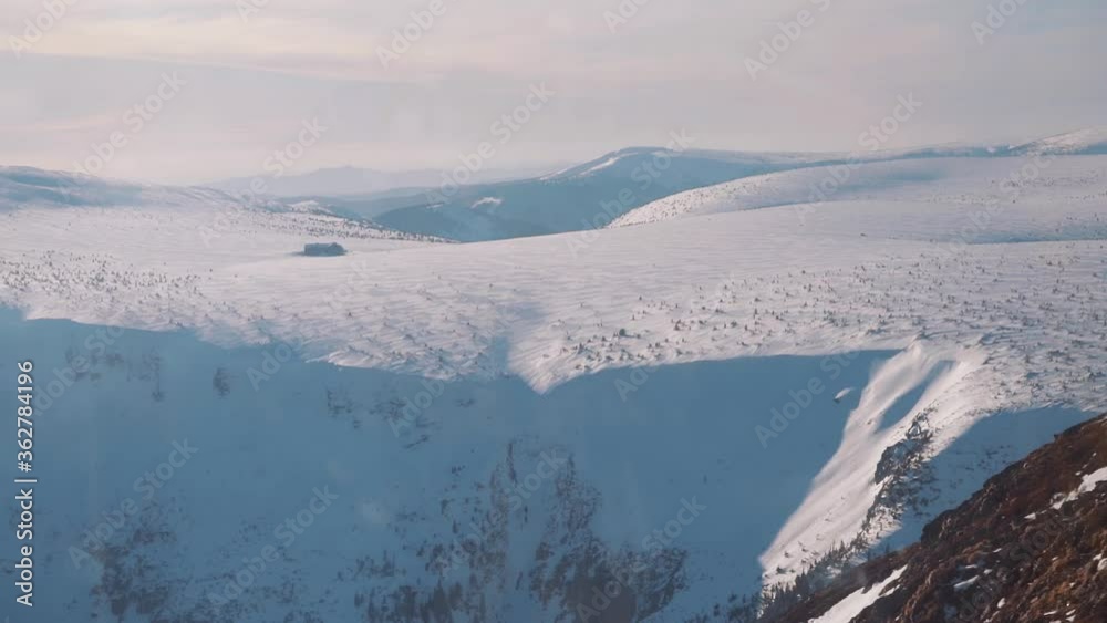 View of snowy mountains from frozen mountain top, krkonose, czechia, europe View of snowy mountains from frozen mountain top, krkonose, czechia, europe