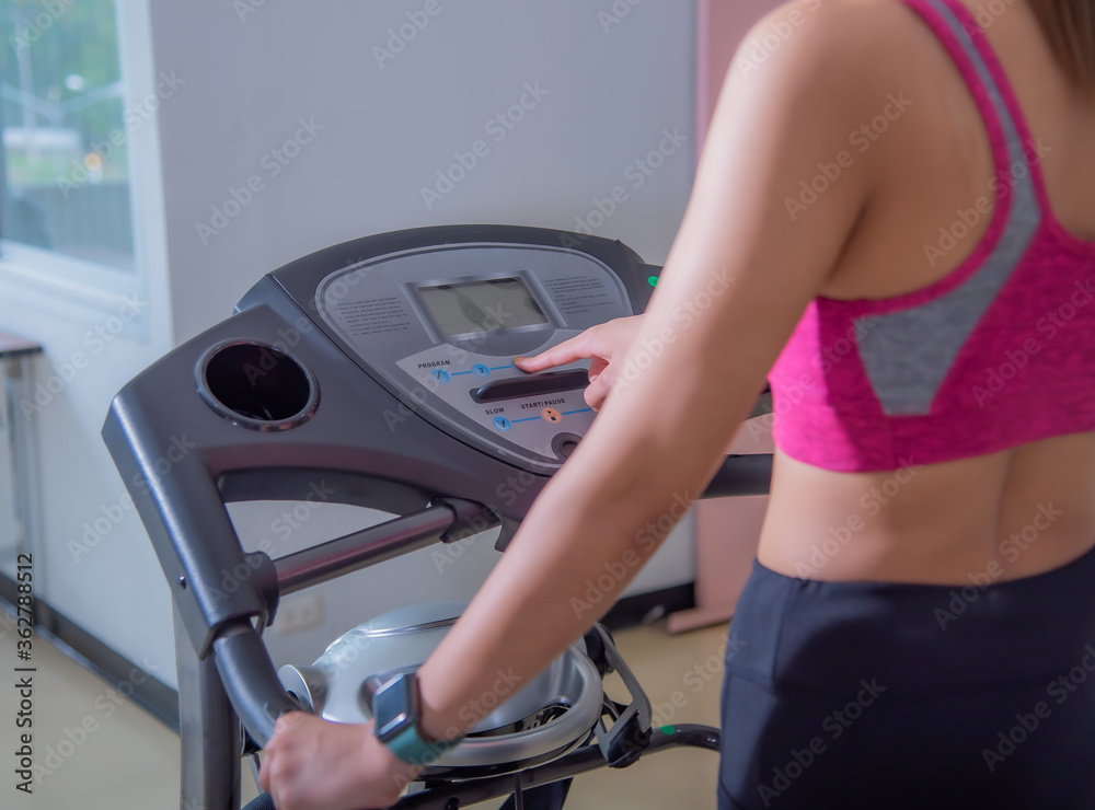Side view women on running track. Girls on treadmill Side view women on running track. Girls on treadmill