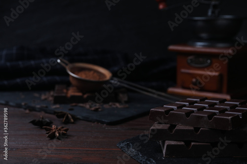 Tasty dark chocolate bars on wooden table