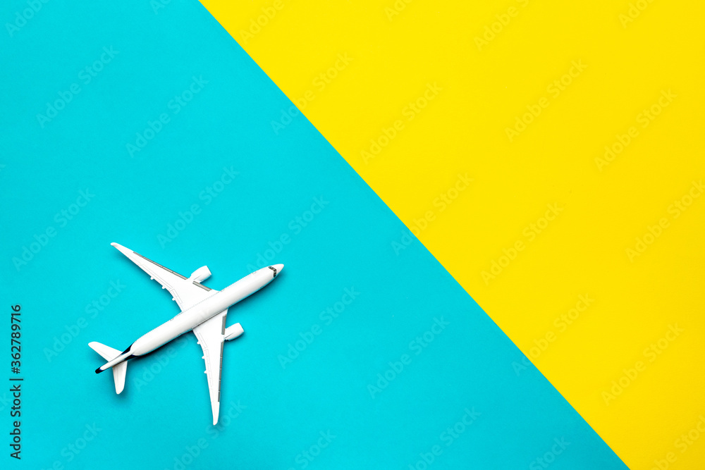 Fototapeta premium Toys kids aircraft backdrop. White toy airplane in close up view with copy space for flight air plane travel concept.