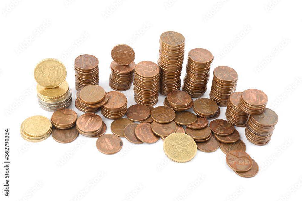 Many different stacked coins isolated on white Many different stacked coins isolated on white