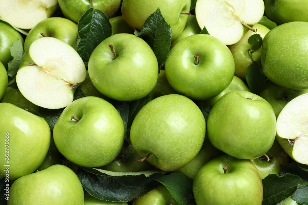 Pile of tasty green apples with leaves as background, top view Pile of tasty green apples with leaves as background, top view