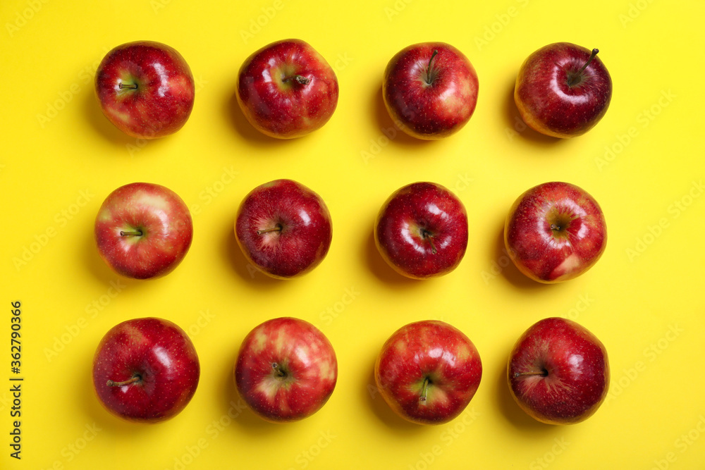 Tasty red apples on yellow background, flat lay Tasty red apples on yellow background, flat lay