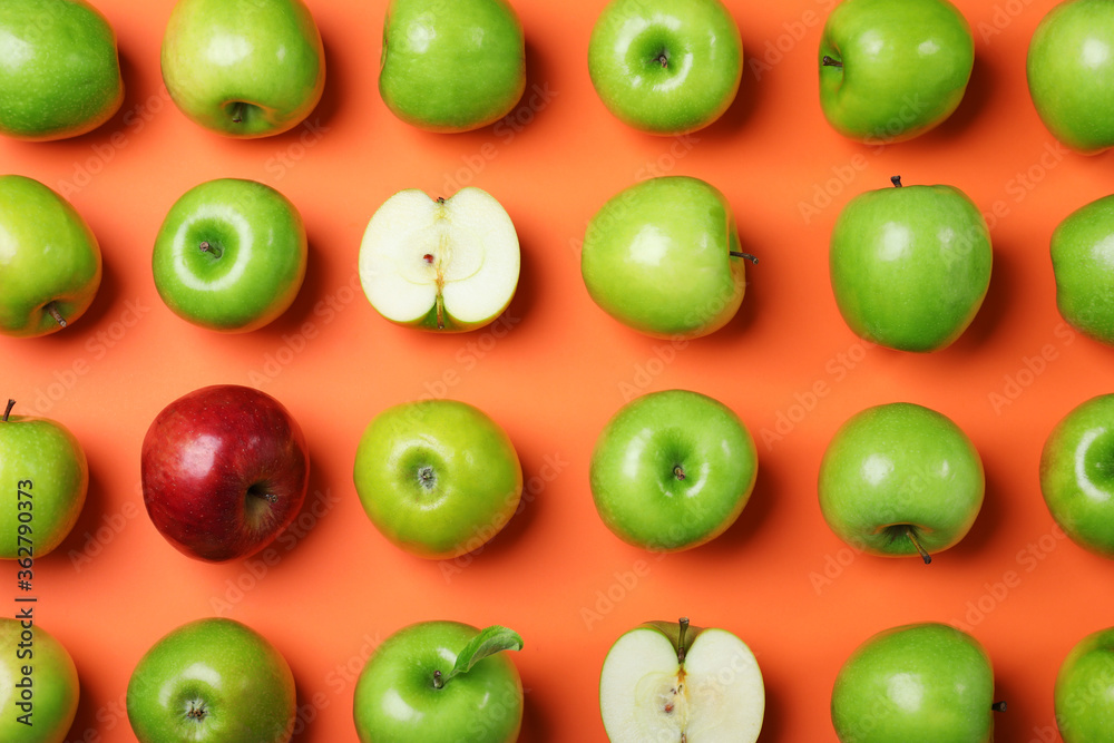 Tasty green apples and red one on orange background, flat lay Tasty green apples and red one on orange background, flat lay