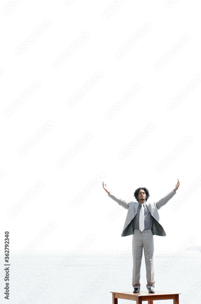 Businessman standing on a table Businessman standing on a table