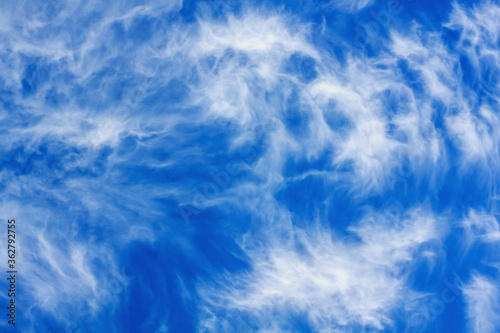 The blue sky is covered with beautiful white cirrus clouds