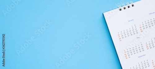 calendar page close up on blue background business planning appointment meeting concept photo