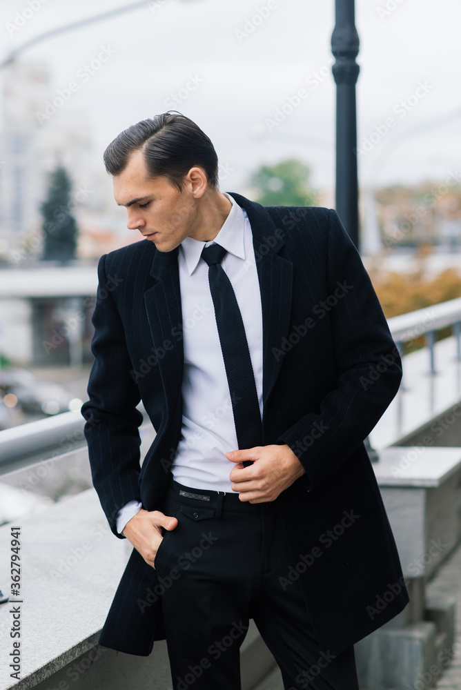 Man in a stylish suit. Businessman in an autumn city, fashion Man in a stylish suit. Businessman in an autumn city, fashion