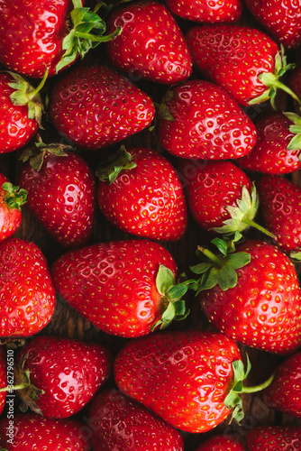 Fresh strawberries as a background. Food background fresh organic strawberries  vertical orientation